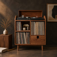 Corner detail of wood record player stand on tapered legs with open cubbies and a drawer beside wood, brass and linen samples