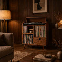 Wood record player stand on tapered legs with open cubbies and a drawer in an evening living room with walnut wall paneling