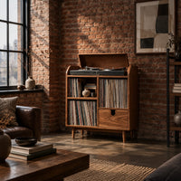 Wood record player stand on tapered legs with open cubbies and a drawer in an industrial loft living room with exposed brick