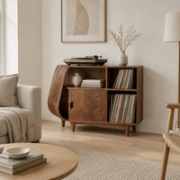 Record player stand with a teardrop shaped side, a wood door and tapered legs in a Scandinavian living room with white walls