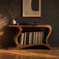 Record player stand with wave shaped sides and a wide open shelf in a dark studio against a charcoal plaster wall