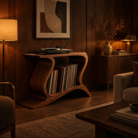 Record player stand with wave shaped sides and a wide open shelf in an evening living room with walnut wall paneling
