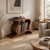 Record player stand with wave shaped sides and a wide open shelf in a Scandinavian living room with white walls
