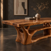 Corner detail of rectangle dining table on a branching tree trunk base beside wood, brass and linen samples