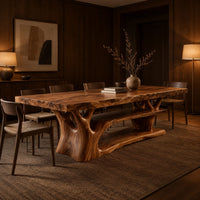 Rectangle dining table on a branching tree trunk base in an evening dining room with walnut wall paneling