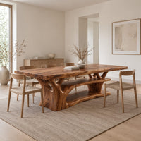 Rectangle dining table on a branching tree trunk base in a Scandinavian dining room with white walls