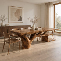 Rectangle dining table with a thick slab top and a branching trunk base in a Scandinavian dining room with white walls