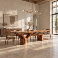 Rectangle dining table with a thick slab top and a branching trunk base in a bright open plan dining room
