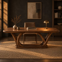 Rectangular desk on arched loop legs joined by a flat wood base in a dark home office at golden hour