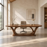 Rectangular desk on arched loop legs joined by a flat wood base in a bright open plan home office