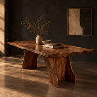 Rectangular dining table with a thick slab top on a wide hourglass pedestal, three-quarter view showing the grain