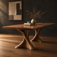 Rectangular dining table on two hourglass pedestal legs, three-quarter view showing the grain