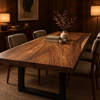 Rectangular wood table top slab with bold swirling grain and a thick edge in an evening dining room with walnut wall paneling