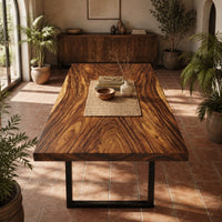 Rectangular wood table top slab with bold swirling grain and a thick edge in a bright dining room with arched windows and plants