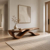 Low bench with a long slab seat on a flowing ribbon shaped base in a Scandinavian entryway with white walls