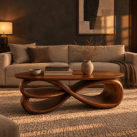 Oval coffee table over layered looping ribbons shaped like an infinity symbol in a dark living room at golden hour
