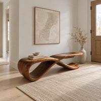 Low ribbon bench with a looping base and a long flat top in a Scandinavian entryway with white walls