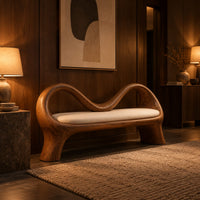 Bench with a wave shaped ribbon frame and a slim pale seat pad in an evening entryway with walnut wall paneling