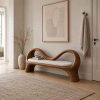 Bench with a wave shaped ribbon frame and a slim pale seat pad in a Scandinavian entryway with white walls