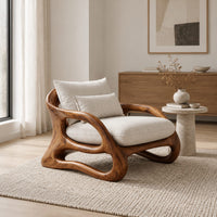 Lounge chair with a looping wooden ribbon frame and cream cushions in a Scandinavian living room with white walls