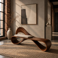 Ribbon loop bench with an arched backrest and a cream cushion in an industrial loft entryway with exposed brick