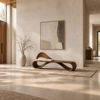 Ribbon loop bench with an arched backrest and a cream cushion in a bright open plan entryway