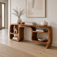 Console table with looping ribbon sides and open cubbies on both ends in a Scandinavian entryway with white walls