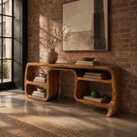 Console table with looping ribbon sides and open cubbies on both ends in an industrial loft entryway with exposed brick