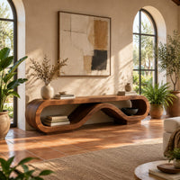Low tv stand shaped as a rolling ribbon loop in a bright living room with arched windows and plants