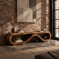 Low tv stand shaped as a rolling ribbon loop in an industrial loft living room with exposed brick