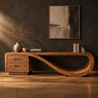 Low tv stand with two drawers and a ribbon shaped looping end in a dark studio against a charcoal plaster wall