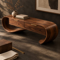 Corner detail of looping wooden bench with a ribbon shaped frame and two drawers beside wood, brass and linen samples