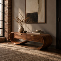 Looping wooden bench with a ribbon shaped frame and two drawers in an industrial loft entryway with exposed brick