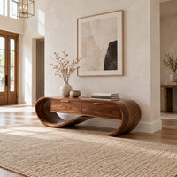 Looping wooden bench with a ribbon shaped frame and two drawers in a bright open plan entryway