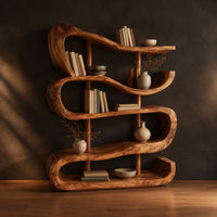 Bookshelf of stacked wavy ribbon shelves on slim wooden posts in a dark studio against a charcoal plaster wall