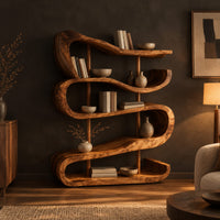 Bookshelf of stacked wavy ribbon shelves on slim wooden posts in a dark living room at golden hour