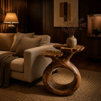 Side table with a looped ring base and two scalloped dish tops in an evening living room with walnut wall paneling