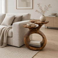 Side table with a looped ring base and two scalloped dish tops in a Scandinavian living room with white walls