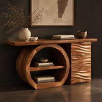 Corner detail of console table with a large circular open shelf frame beside a wave carved cabinet beside wood, brass and linen samples