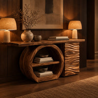 Console table with a large circular open shelf frame beside a wave carved cabinet in an evening entryway with walnut wall paneling