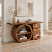 Console table with a large circular open shelf frame beside a wave carved cabinet in a Scandinavian entryway with white walls