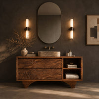 Corner detail of bathroom vanity with rippled carved fronts and an arched base beside wood, brass and linen samples