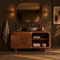 Bathroom vanity with ripple carved doors, open shelves and short tapered feet in a dark bathroom at golden hour