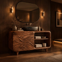 Bathroom vanity with ripple carved doors, open shelves and short tapered feet in an evening bathroom with walnut wall paneling