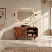 Bathroom vanity with ripple carved doors, open shelves and short tapered feet in a bright open plan bathroom
