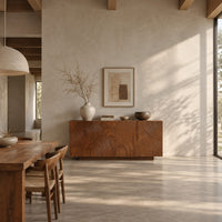 Four door sideboard carved with concentric ripple rings on a plinth base in a bright open plan dining room