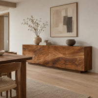 Low sideboard with four carved wave panels on a recessed plinth base in a Scandinavian dining room with white walls
