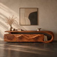 Corner detail of low tv stand with ripple carved panels and a looped sweeping end beside wood, brass and linen samples