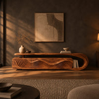 Low tv stand with ripple carved panels and a looped sweeping end in a dark living room at golden hour
