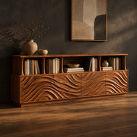 Tv stand with ripple carved front panels and four open display shelves, three-quarter view showing the grain